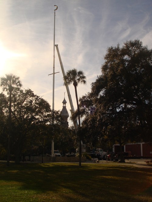 Lift raised to the top of a tall flagpole for service