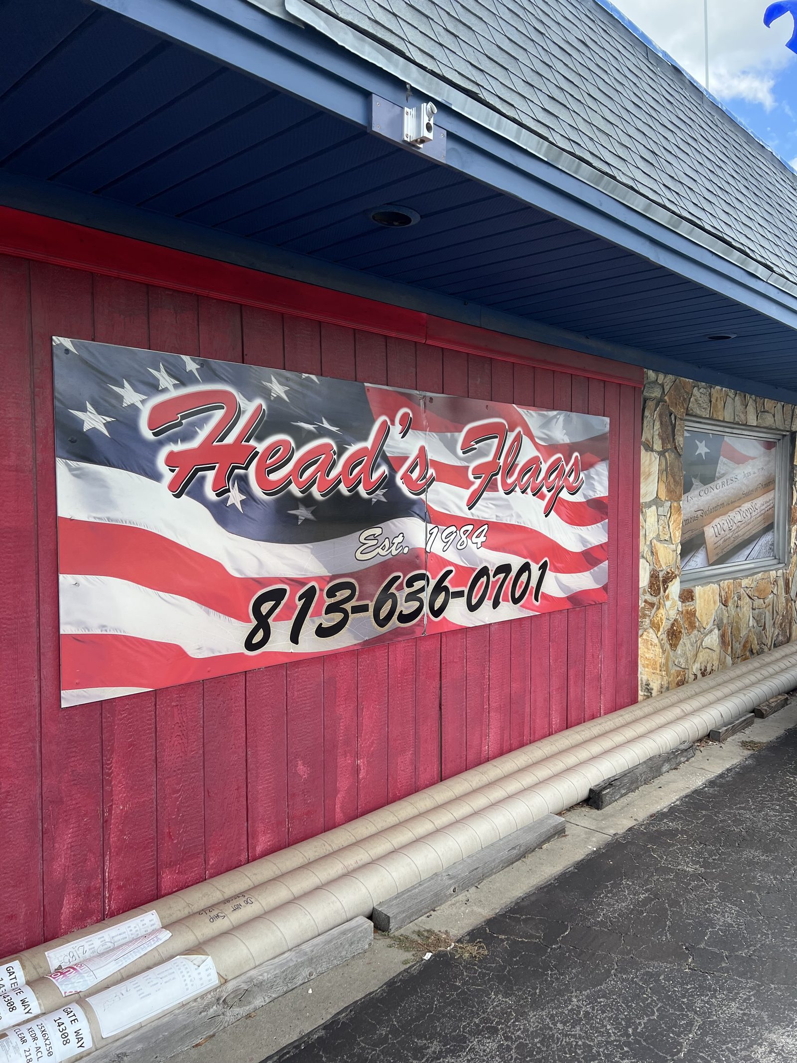 Head's Flags painted mural with the phone number