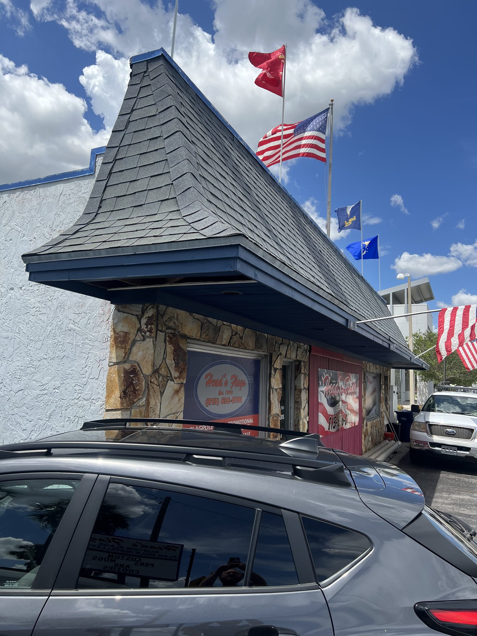 Flags flying over the shop on Henderson Blvd
